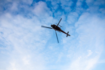 Fototapeta na wymiar helicopter in the sky with clouds