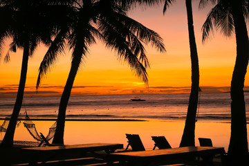 Beach Chairs and Hammocks at Paradise Island Resort - Orange Sunset in Bohol, Philippines