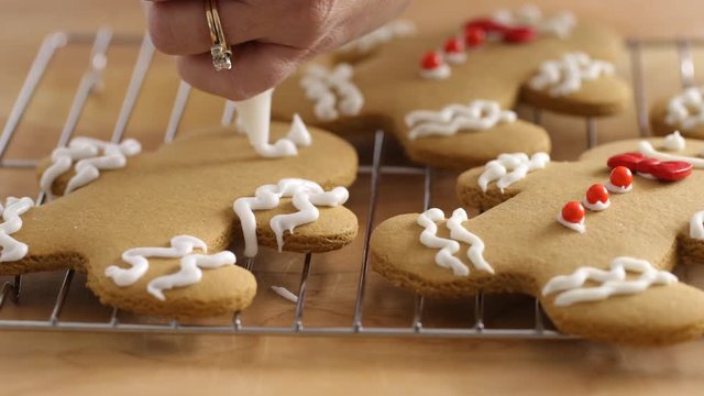 Frosting gingerbread cookies, closeup