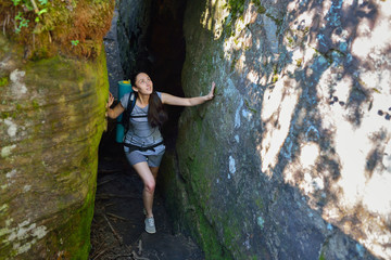 Woman Hiker Backpacker exploring narrow canyon