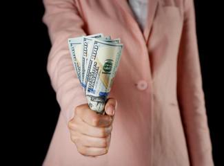 Woman with money on black background
