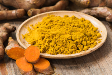 Fresh turmeric roots with turmeric powder