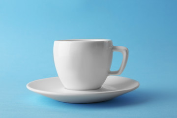White coffee cup on blue background