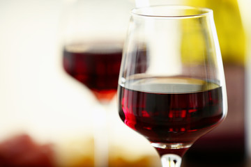 Glasses with red wine on blurred background