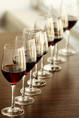 Glasses with red wine in a row on a table