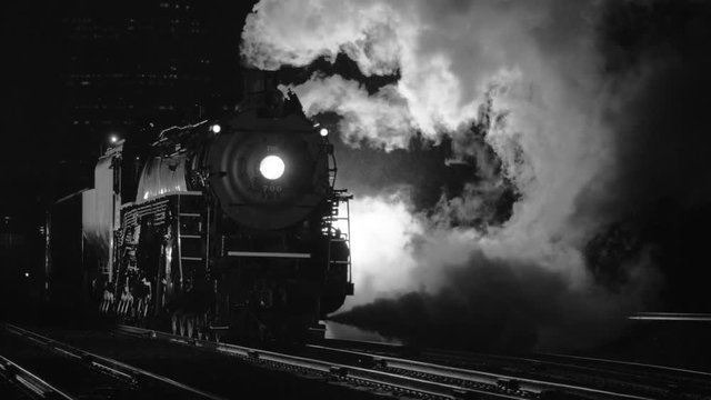 Steam locomotive at night in black and white