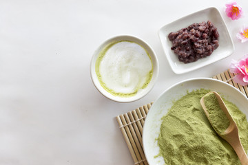 green tea latte on white table background. over light