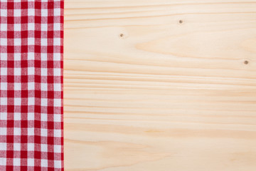 Checkered tablecloth red on the wooden background/ texture 