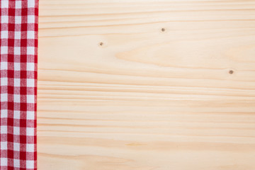 Checkered tablecloth red on the wooden background/ texture 