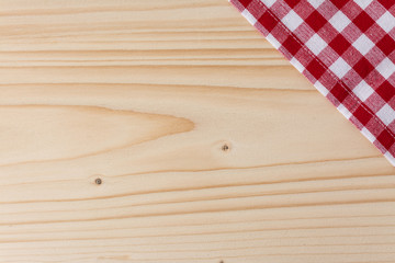 Checkered tablecloth red on the wooden background/ texture 
