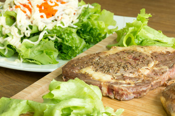 beefsteak on wood plate
