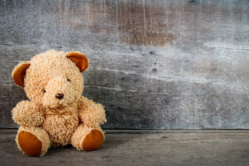Cute teddy bears sitting on old wood background 