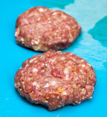 Two fresh raw beef burgers