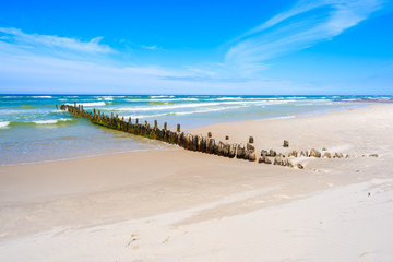 Breakwaters on sandy beach in Debki village, Baltic Sea, Poland