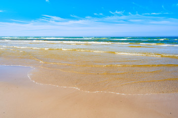 Fototapeta na wymiar Sandy Debki beach with waves, Baltic Sea, Poland