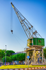 Naklejka premium Old crane transformed in a monument in port of Tarragona, Spain
