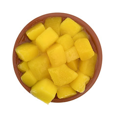 Diced mangoes in a small dish top view isolated on a white background.