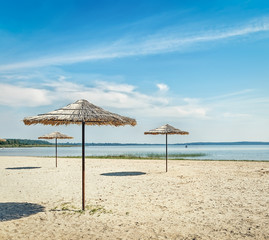 .Sunshades on the beach at the lake.