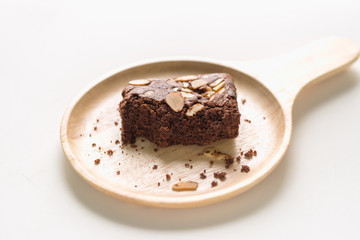 Brownies on wooden plate on white background.