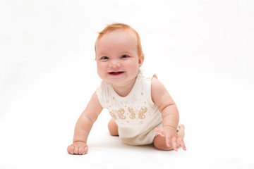 Cute kid playing with his feet. Portrait of a beautiful baby girl

