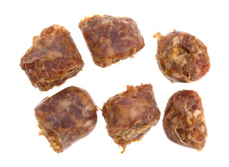 Bratwurst chunks on a white background.