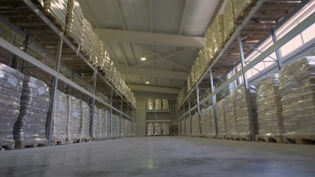 Large furniture warehouse. Mezzanine shelving with large packages of food ready for dispatch. Warehouse wholesaler.