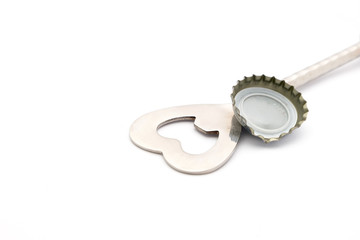 close up of bottle opener and cap on white background with clipp