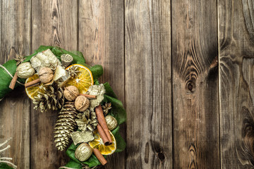 Christmas wreath with dried fruits on wooden door