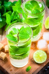 fresh mojito cocktails with lime, mint and ice in glass
