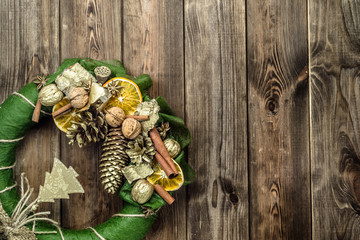 Christmas wreath with dried fruits on wooden door