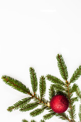 Christmas tree branch with glass ball isolated on white background
