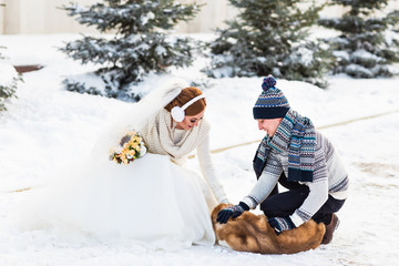 Fototapeta na wymiar Young couple with dog winter outdoors fun.