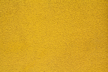 Fototapeta premium Yellow stucco relief on the wall of the house. Backgrounds and t