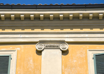 Architectural detail of an ancient decorated capital in a Italian house
