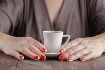 Fototapeta na wymiar Morning cup of espresso and hand