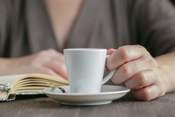 Woman drinking a cup of hot coffee