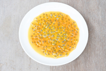 Passion fruit on plate on  wooden background
