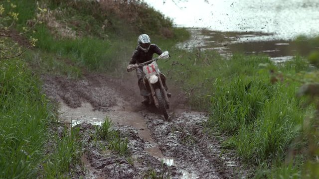 Man rides motorcycle through mud in slow motion, shot on Phantom Flex 4K
