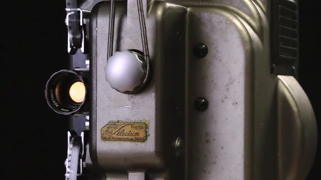 Vintage 8mm Film Projector rotating on a dark background