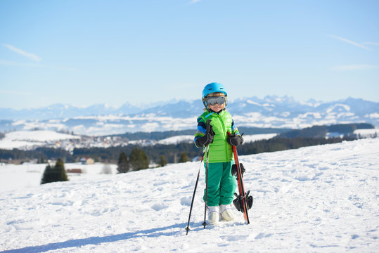 Skiing, winter fun,happy  skier boy enjoying ski holiday in the mountains
