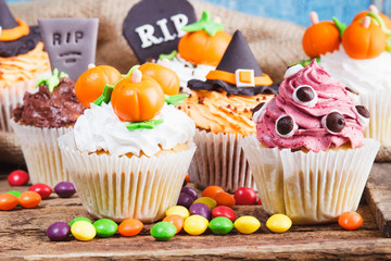 Halloween cupcakes with colored decorations