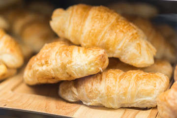 Tasty croissants on grey wooden background