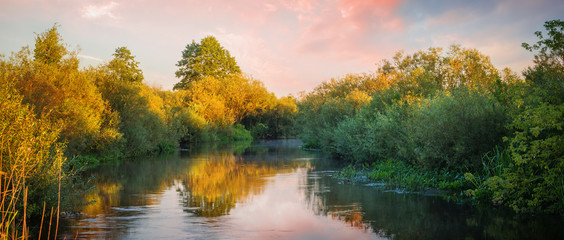 Landscape with river during sunset in summer time