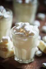 Mousse of white chocolate with marshmallow, vintage wooden backg