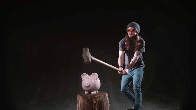 Man smashing piggybank with hammer in slow motion, shot on Phantom Flex 4K at 1000 fps