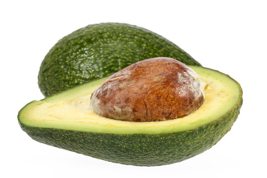 Half  avocado with stone isolated on white background