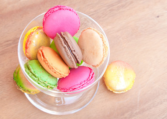 Colorful french sweets macarons on wooden table