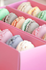 Colorful french sweets macarons in a pink box