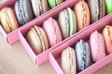 Colorful french sweets macarons in a pink box