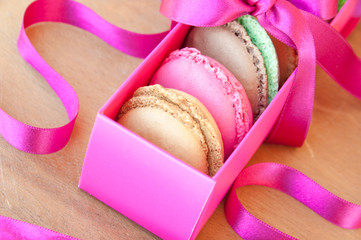 Colorful french sweets macarons in a pink box